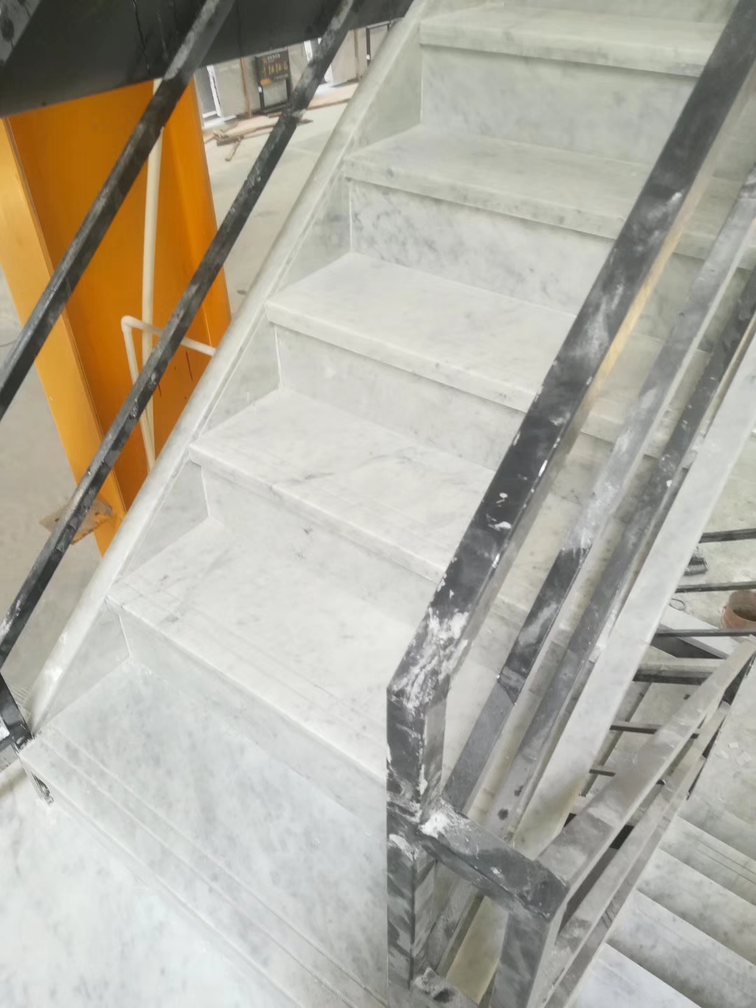 Carrara white marble steps risers in staircase
